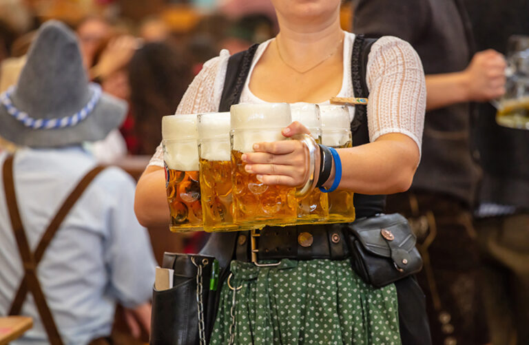 Waitress carrying the big mugs of beer at the Oktoberfest